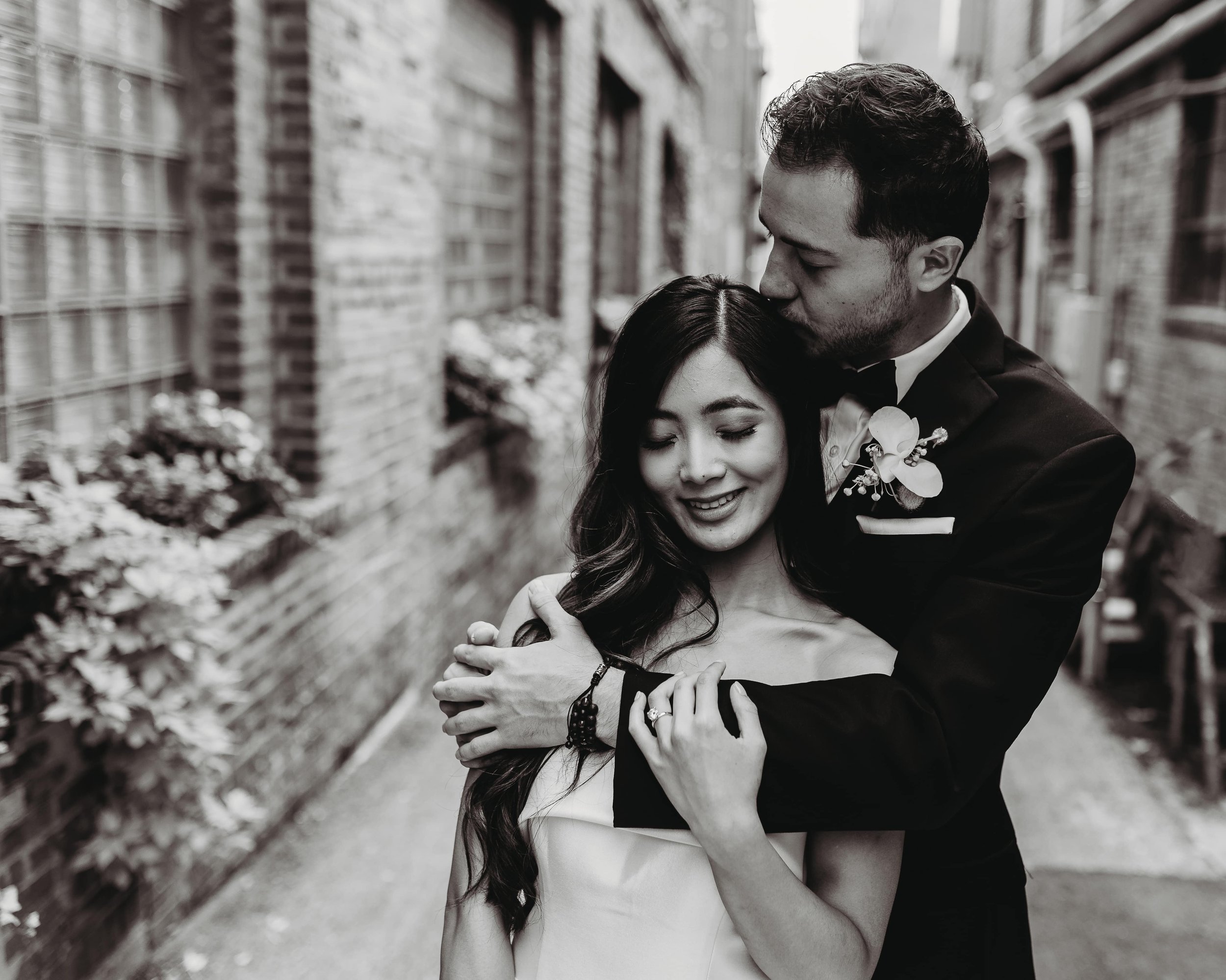black and white portrait of a bride and groom in the Crossroads alley outside of Outreach Event Space