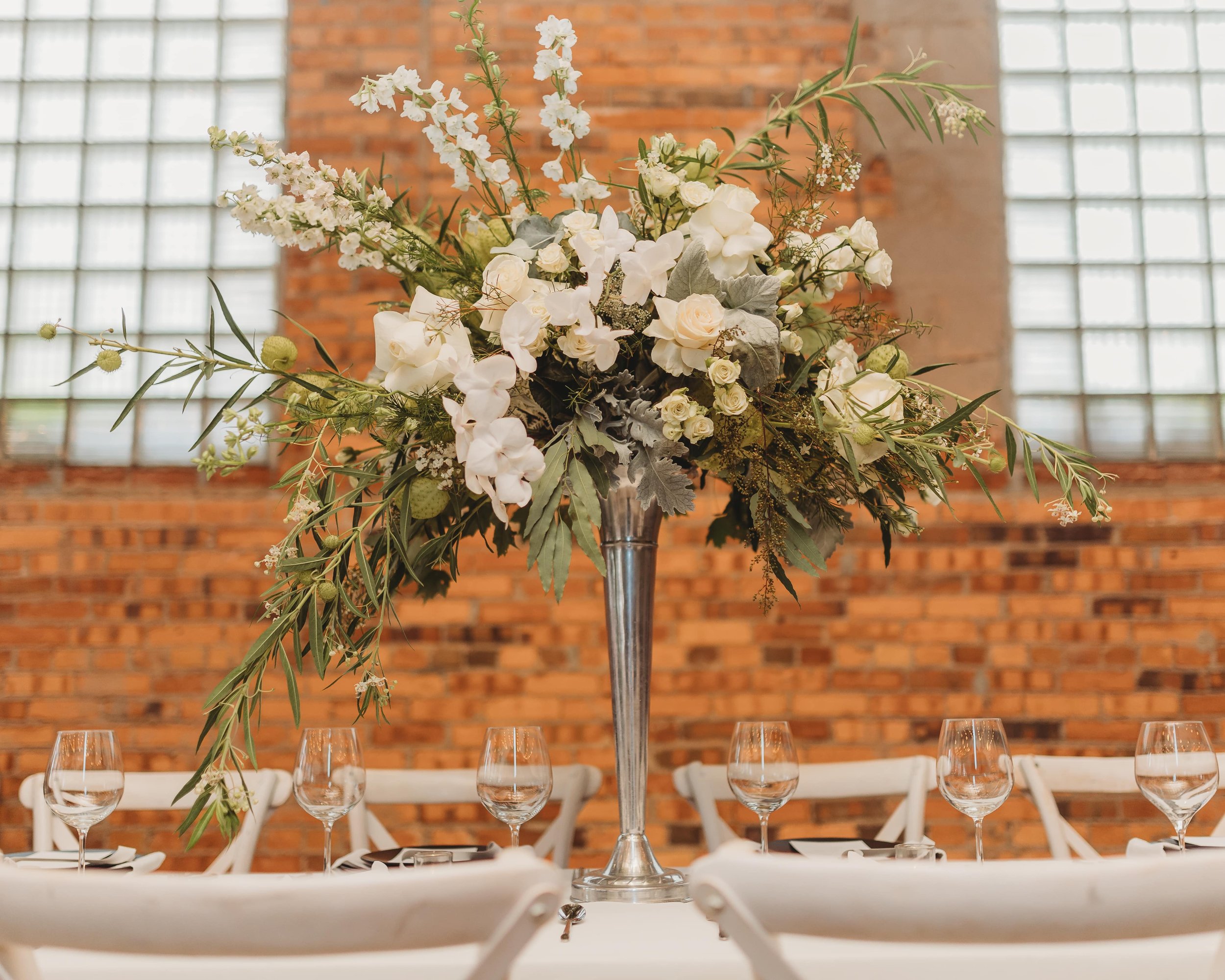large white and greenery centerpiece at an Outreach Event Space wedding