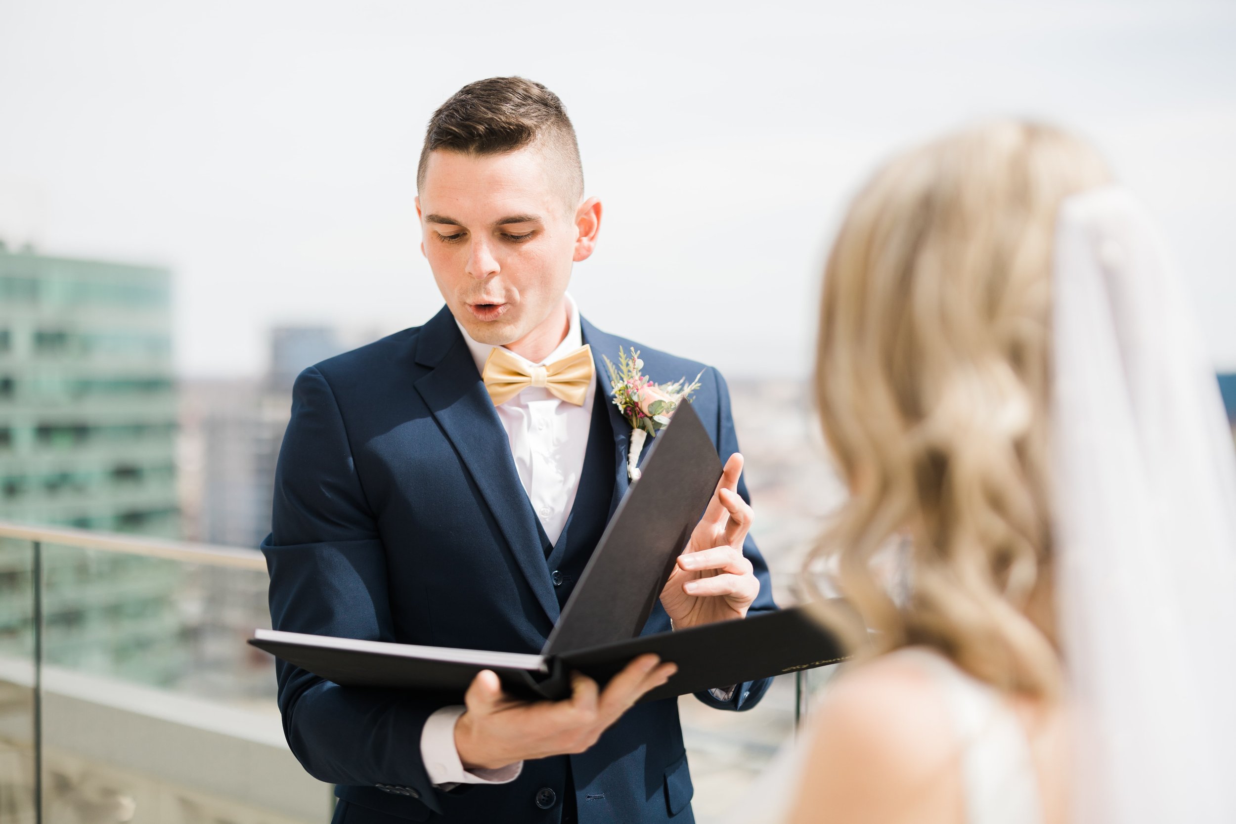 Groom reacting to a wedding gift from his bride on the Starlight Terrace at Hotel Kansas City