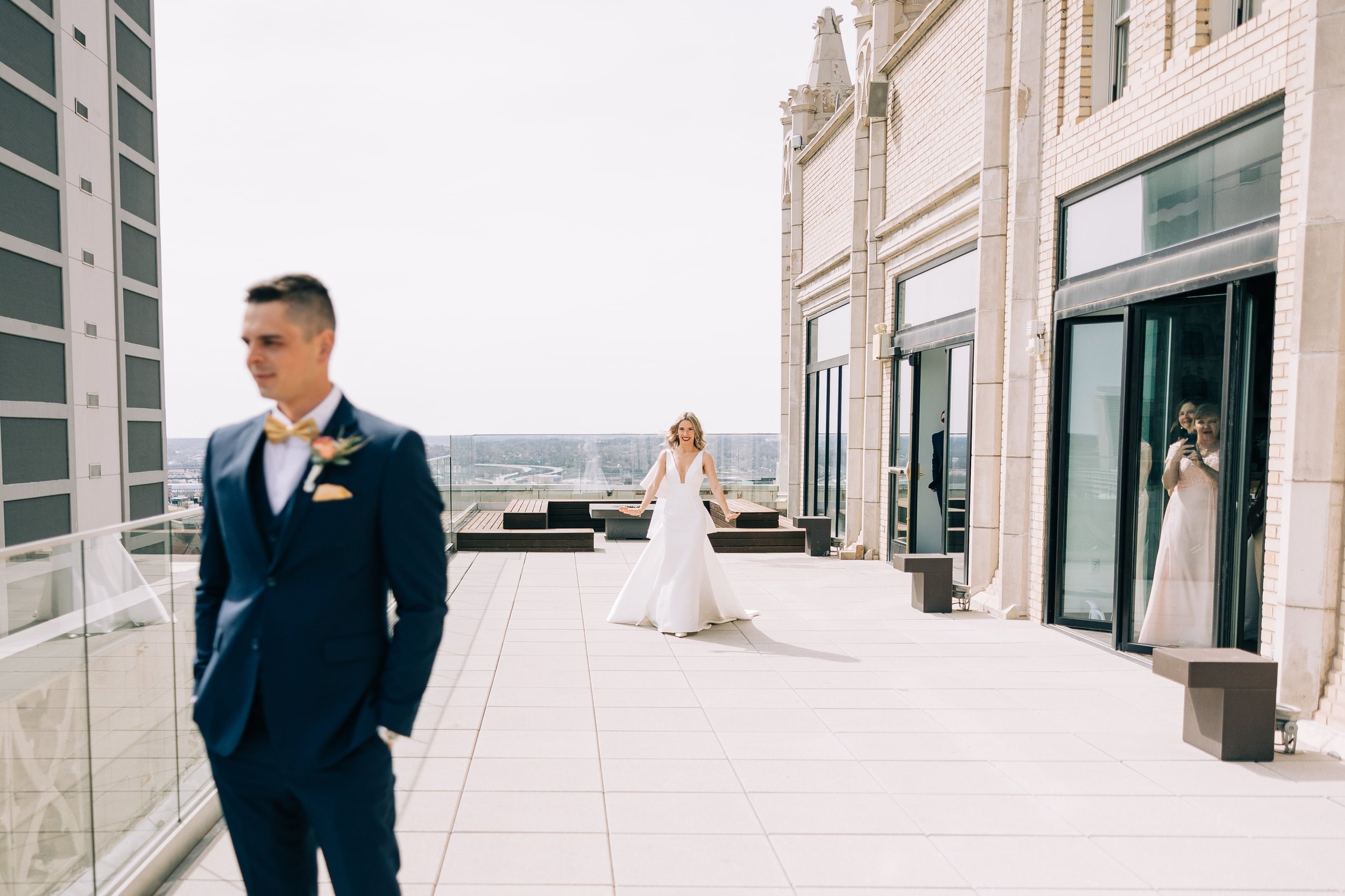 Bride approaching her groom on the Starlight Terrace at Hotel Kansas City for their first look