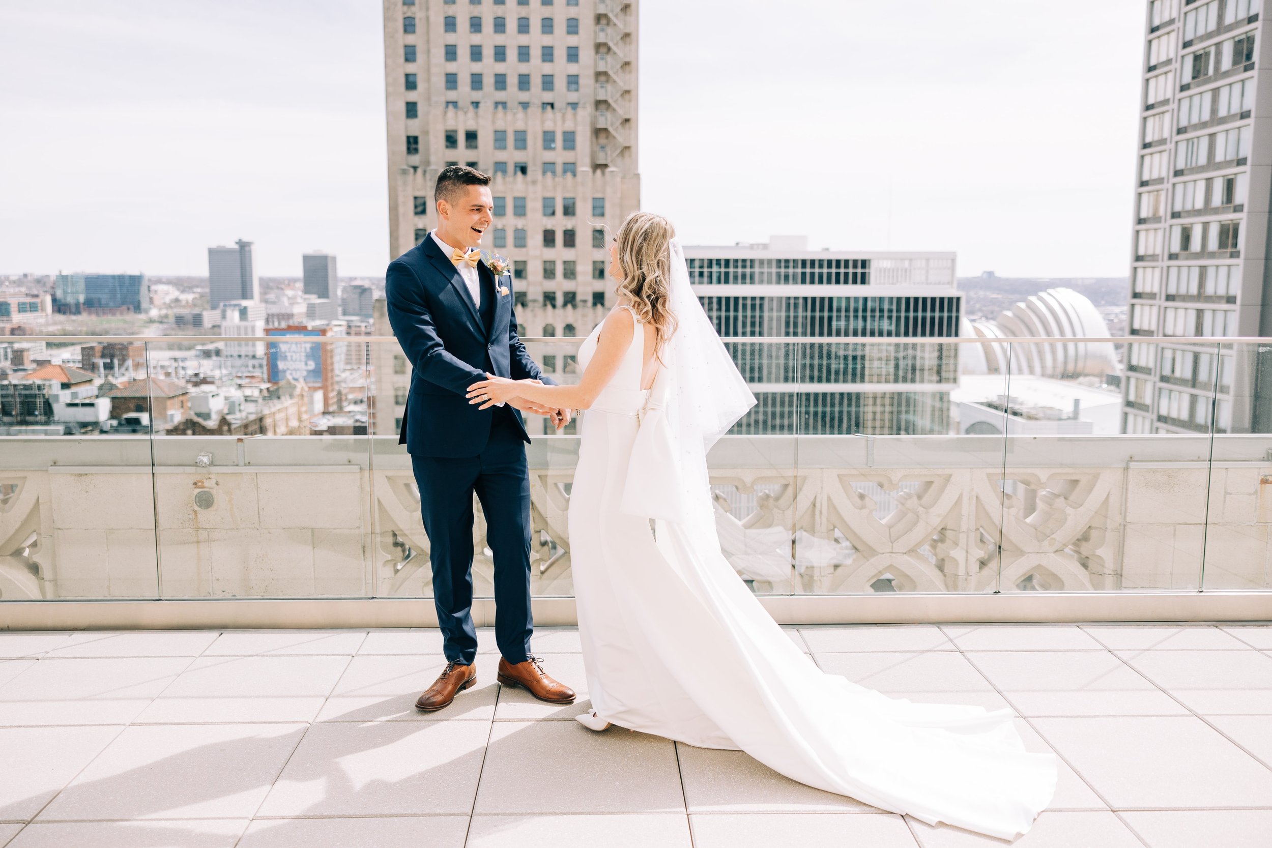 Groom admires his bride on the Starlight Terrace at Hotel Kansas City during their first look