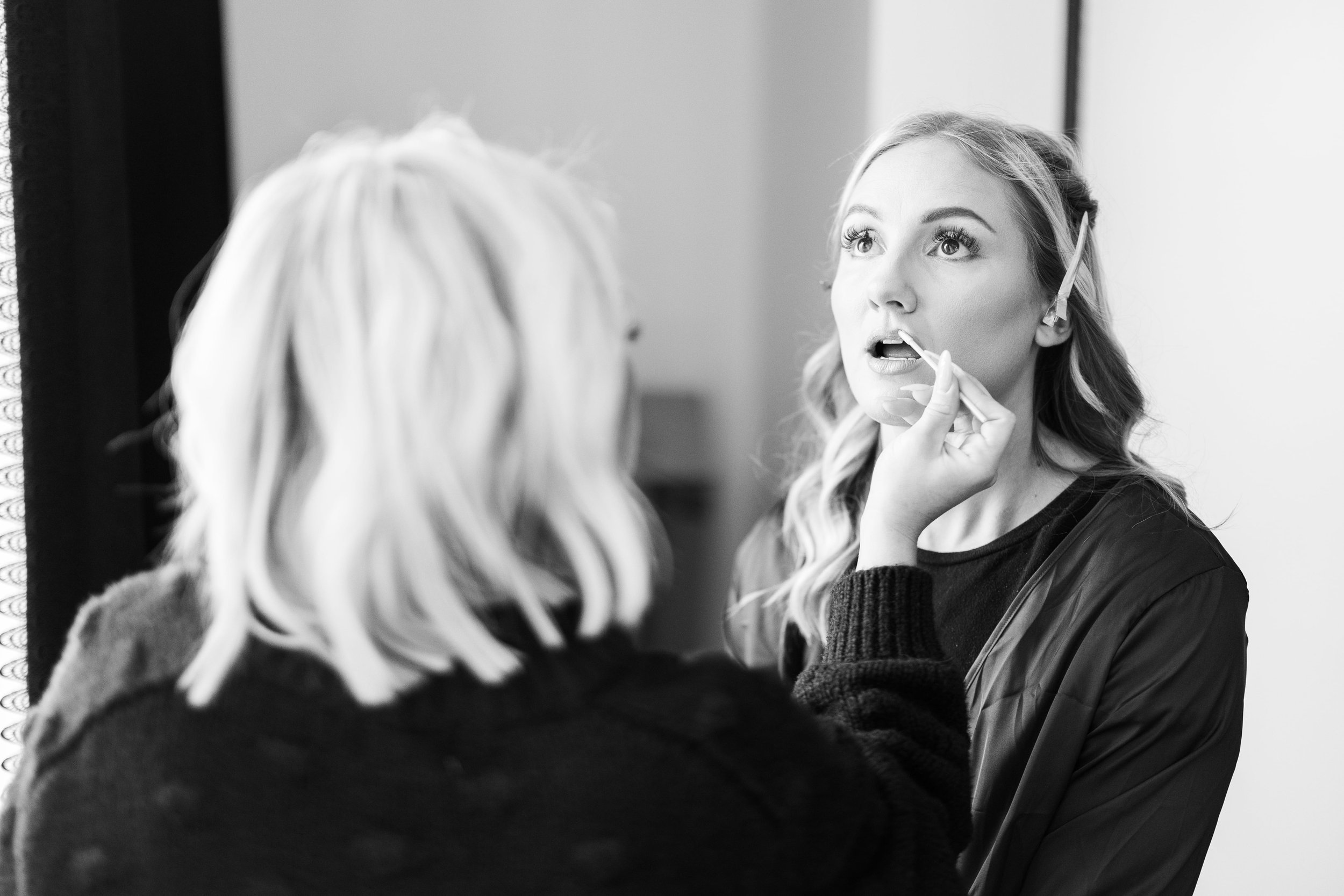 Bridesmaid getting her makeup done in the Hotel Kansas City suites
