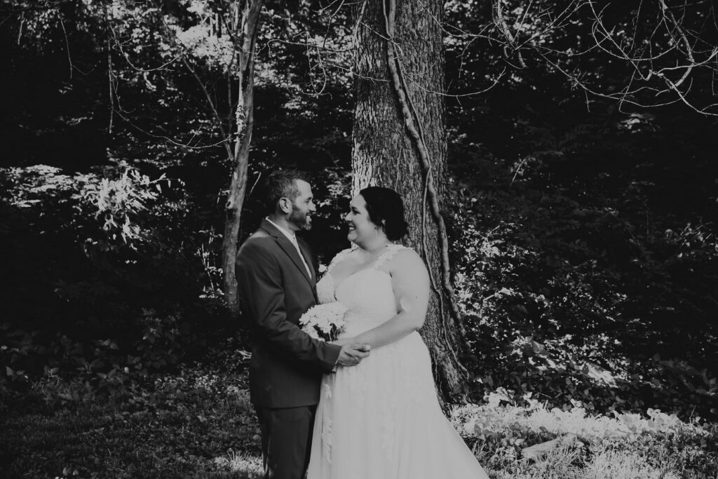 Black and white image of a bride and groom smiling at their wedding at Roanoke Park in Kansas City
