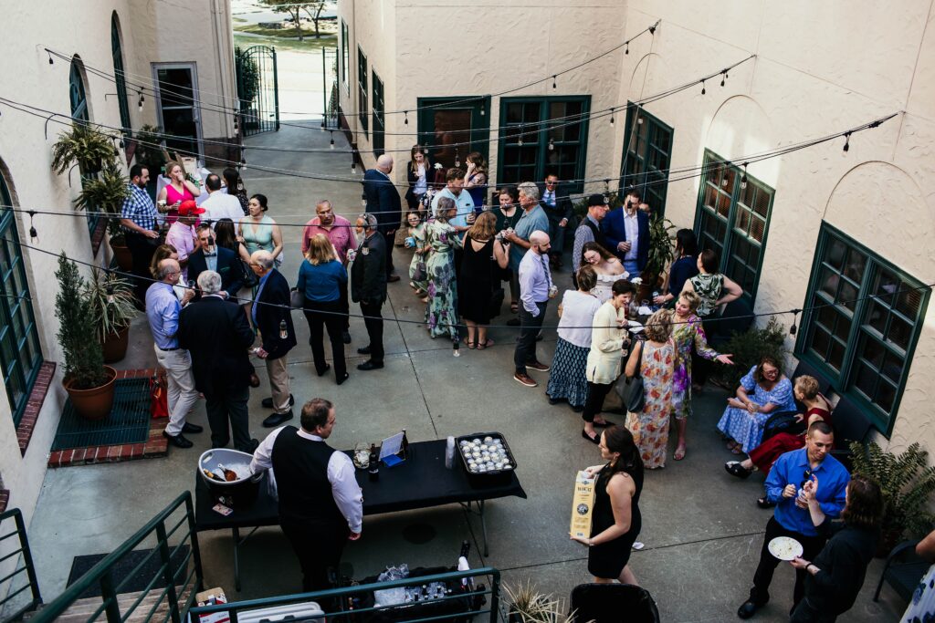 Overhead photo of guests at a La Villa KC wedding reception in the courtyard for cocktail hour