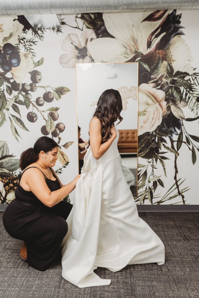 wedding planner (not day of coordinator) gets bride into dress