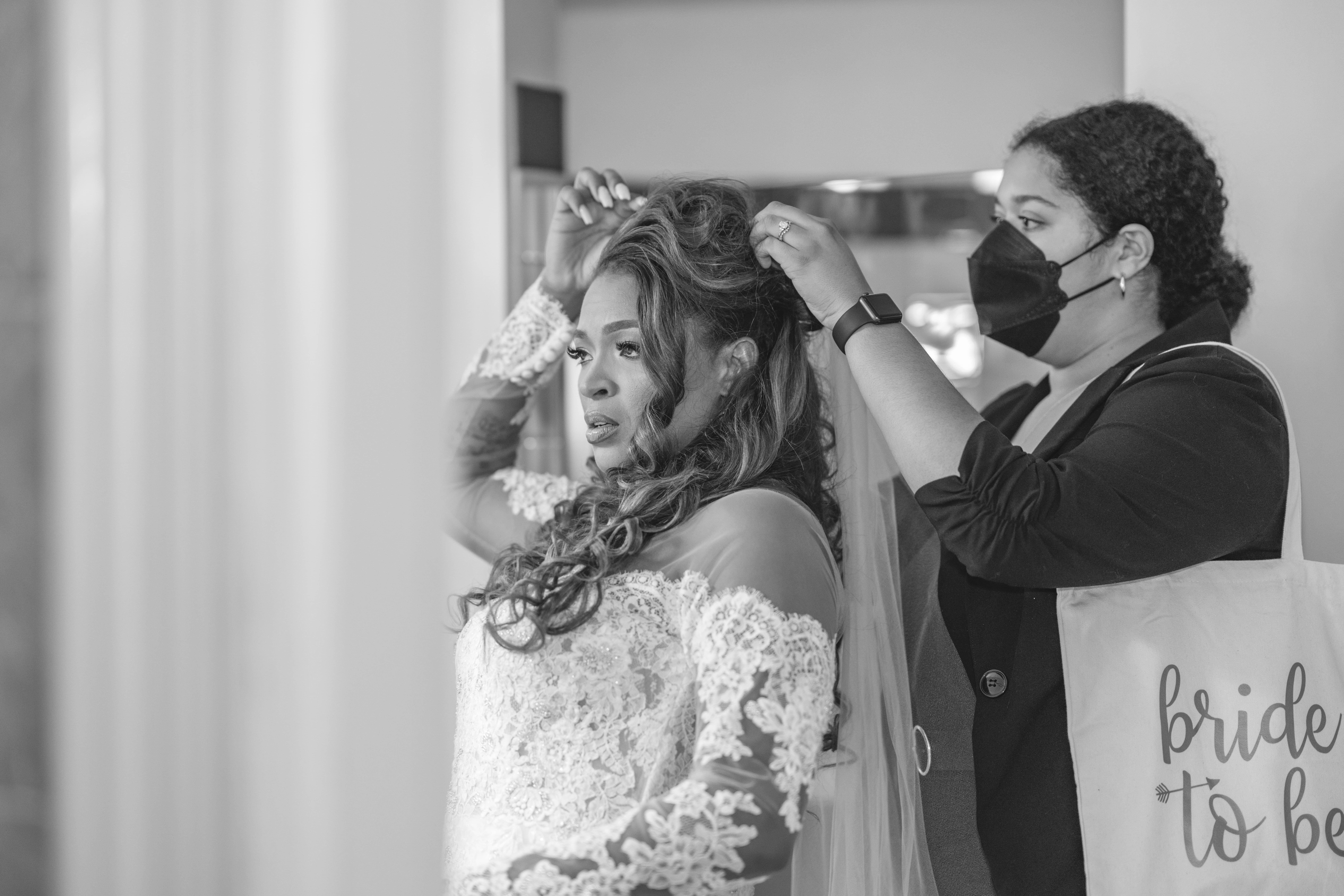 Kansas City wedding planner helping a bride put on her veil