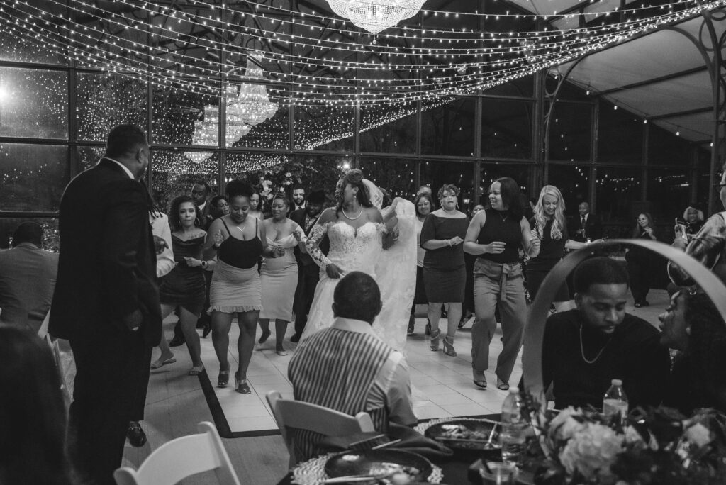 bride and guests dancing at her avent orangery greenhouse wedding