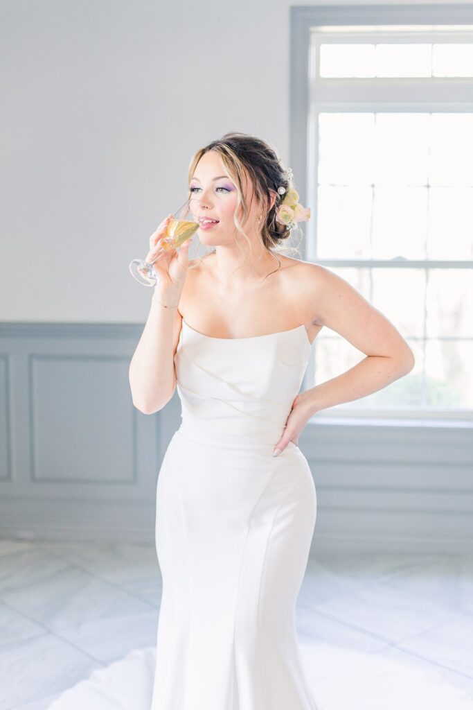 bride sipping champagne at 1890 event space