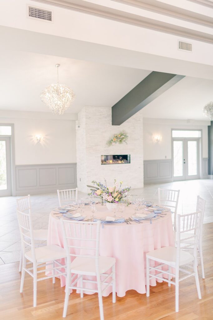 pink guest table in front of fireplace at 1890 event space