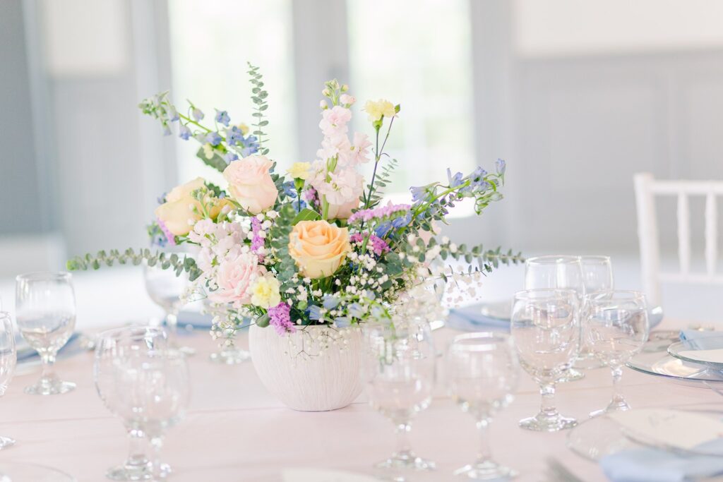 white vase pastel floral centerpiece with baby's breath at 1890 event space