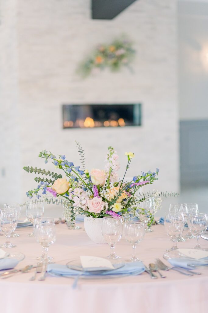 colorful floral centerpiece on pink linens at 1890 event space
