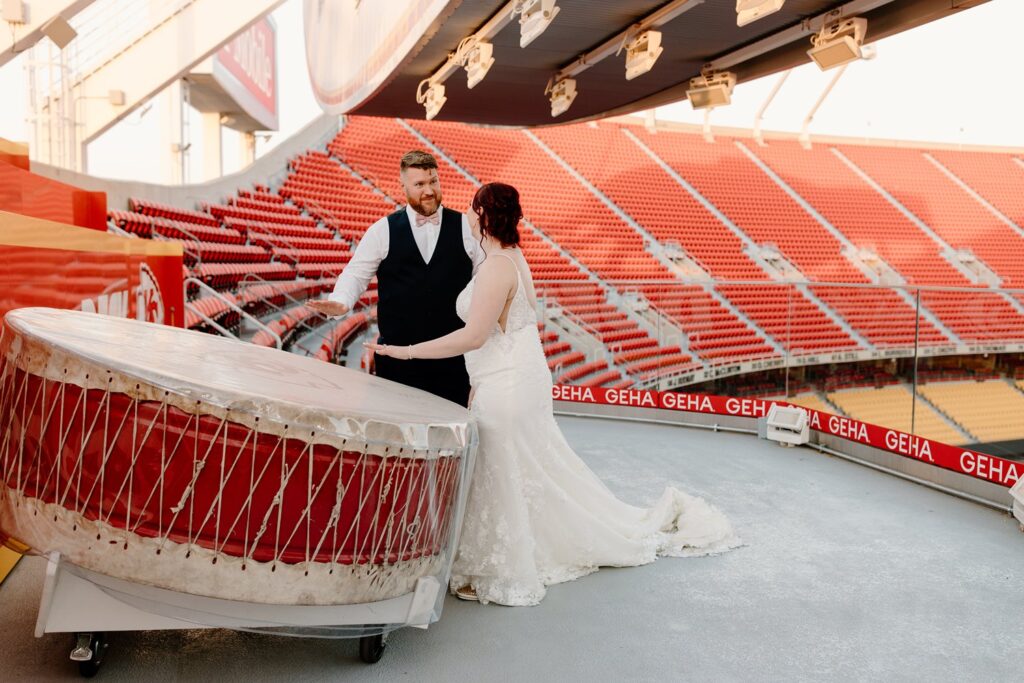 bride and groom hitting the drum on the drum deck at arrowhead