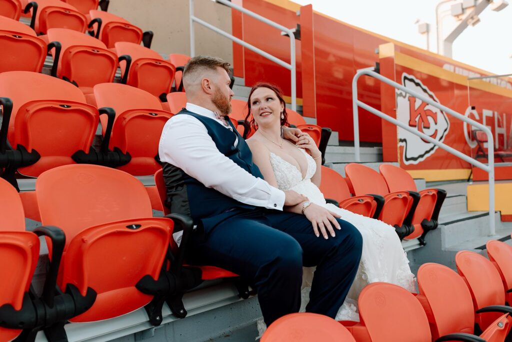 couple talking in the stands at arrowhead on their wedding day