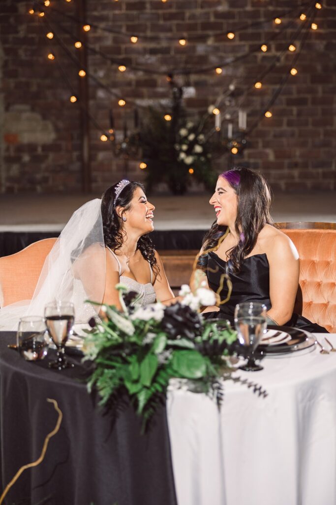 brides at black and white sweetheart table