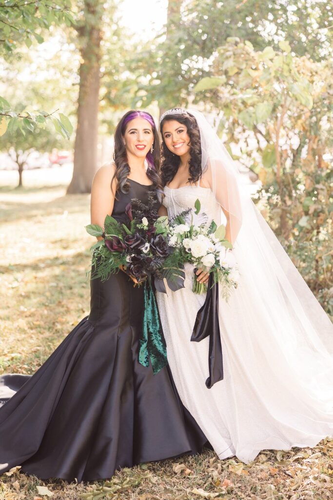 two brides- one in white and one in black- posing in Kansas City