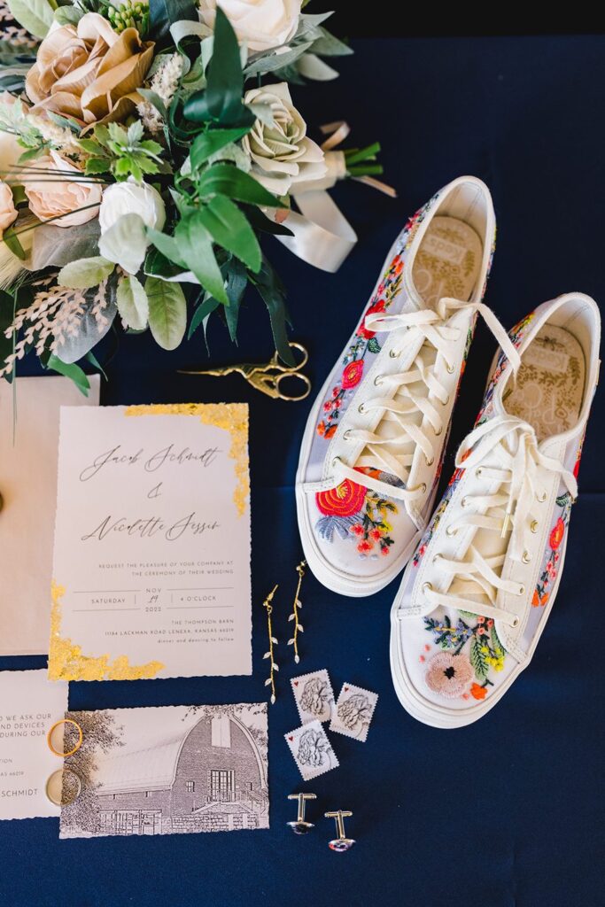 gold foiled wedding invitation and colorful embroidered shoes