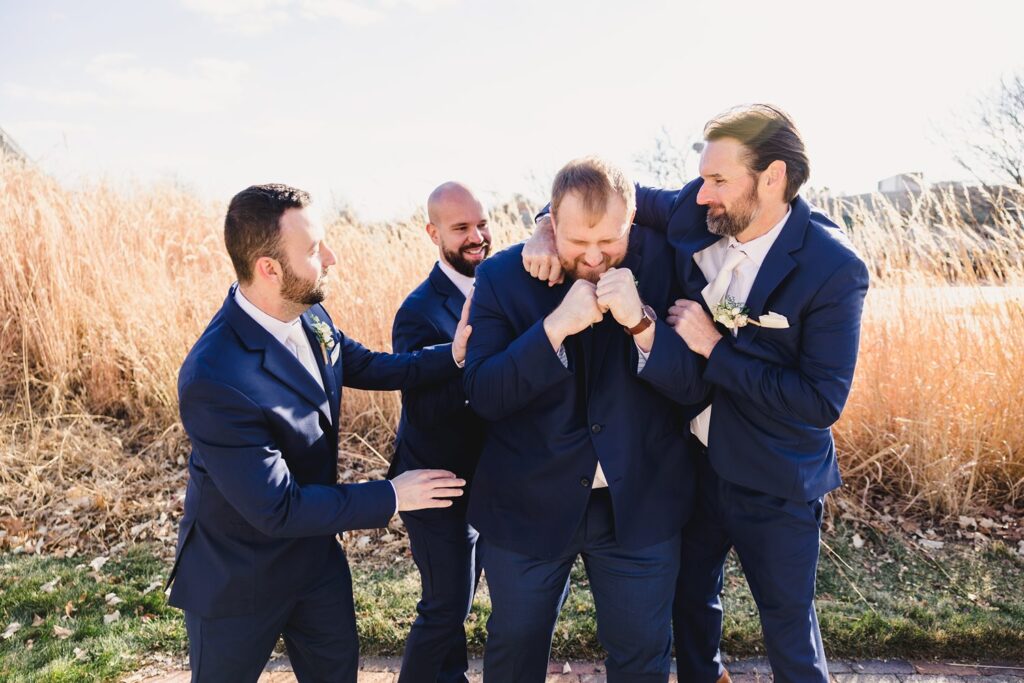 groomsmen laughing at Thompson Barn