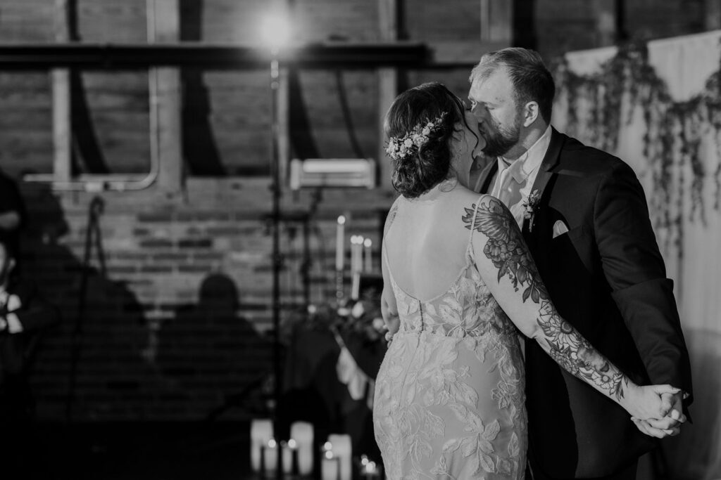 sweet kiss during first dance at Thompson Barn wedding