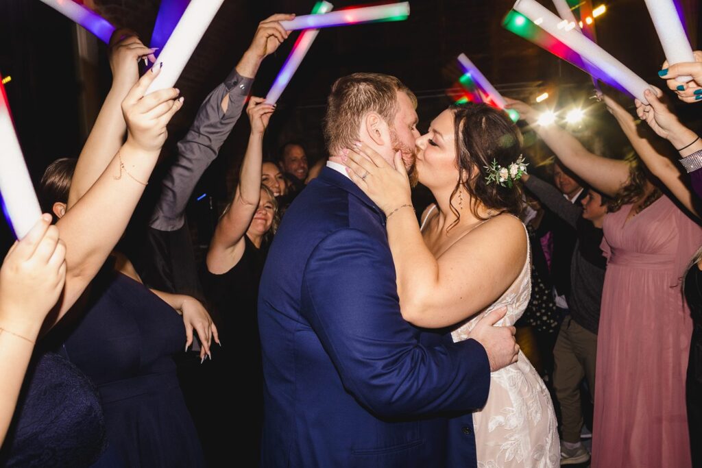 couple kissing during glowstick exit at Thompson Barn wedding