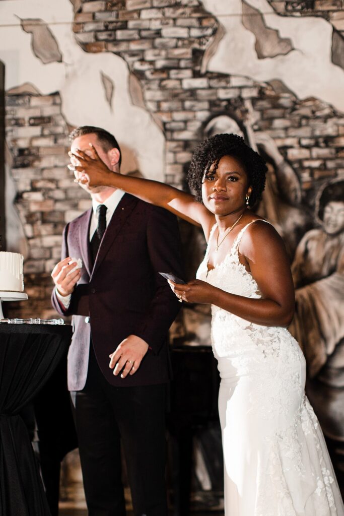 bride smashing cake in the groom's face at 28 Event Space Kansas City Room
