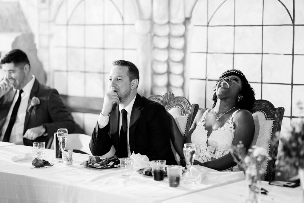 newlyweds listening to toasts at 28 Event Space Kansas City Room wedding reception