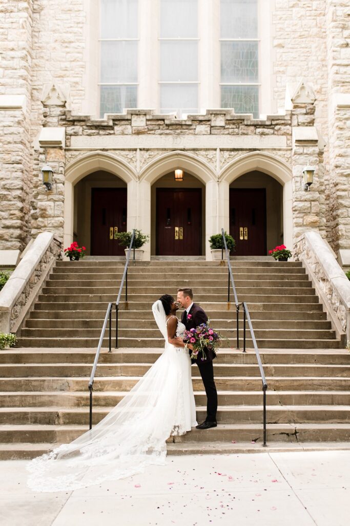 bride and groom in front of Trinity United Methodist Church