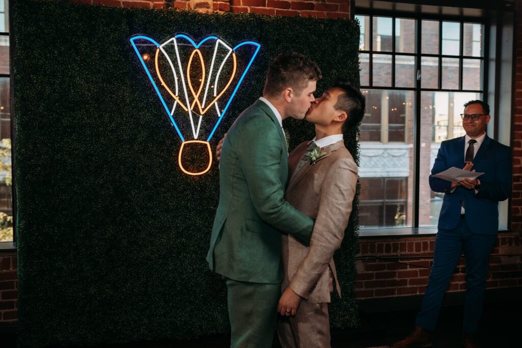 first kiss at industrial wedding ceremony