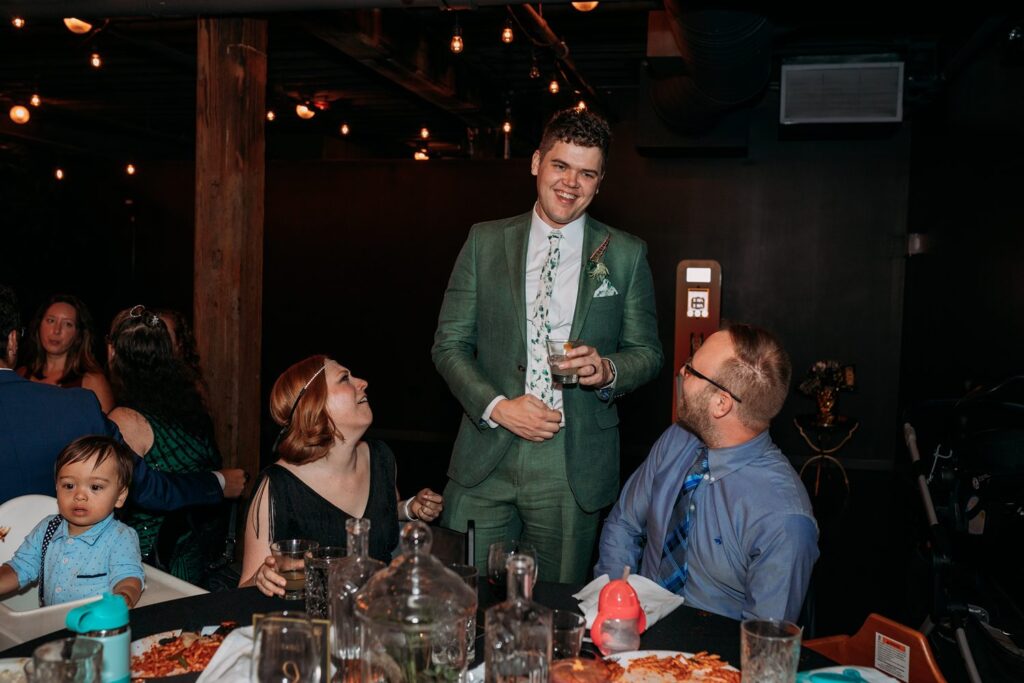 groom with guests at industrial wedding at Tom's Town