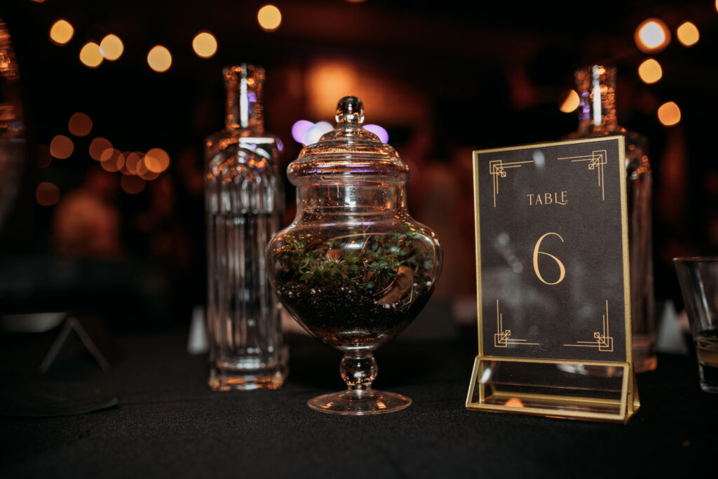 art deco table number and terrarium at industrial wedding