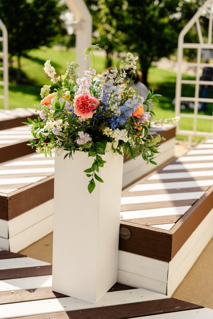 outdoor wedding ceremony florals at pavilion event space