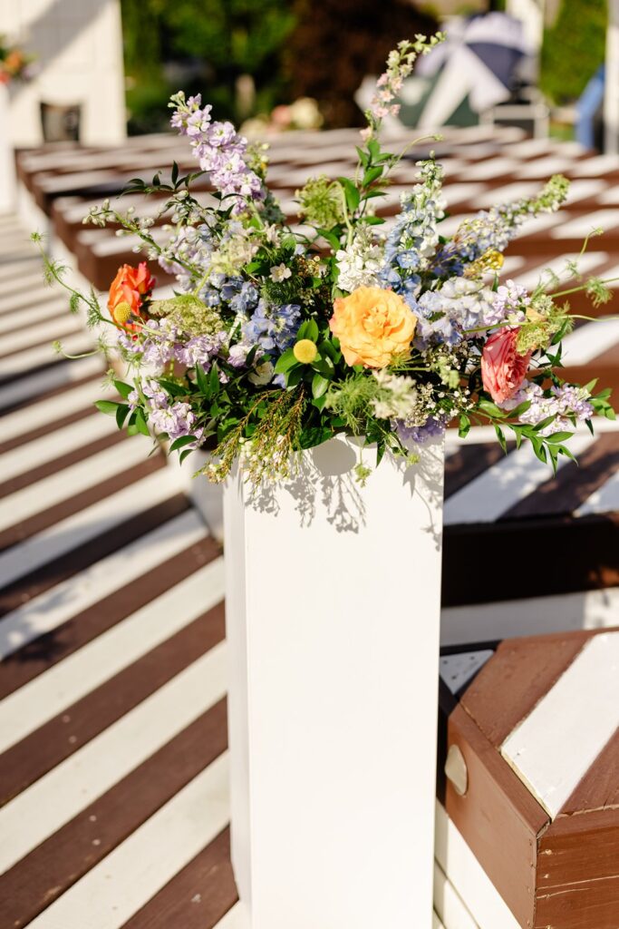 outdoor wedding ceremony florals at pavilion event space