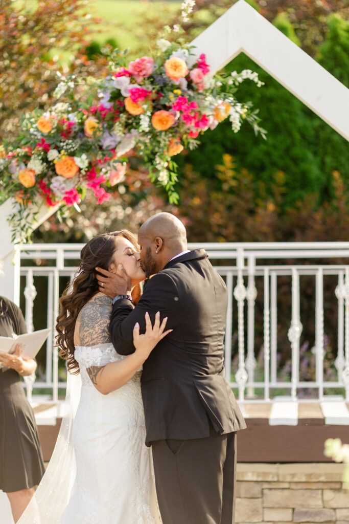 outdoor wedding ceremony first kiss at pavilion event space