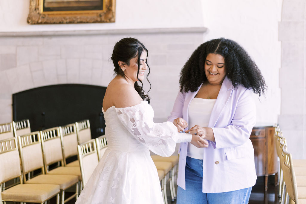 wedding planner helping with dress at Oakwood Country Club