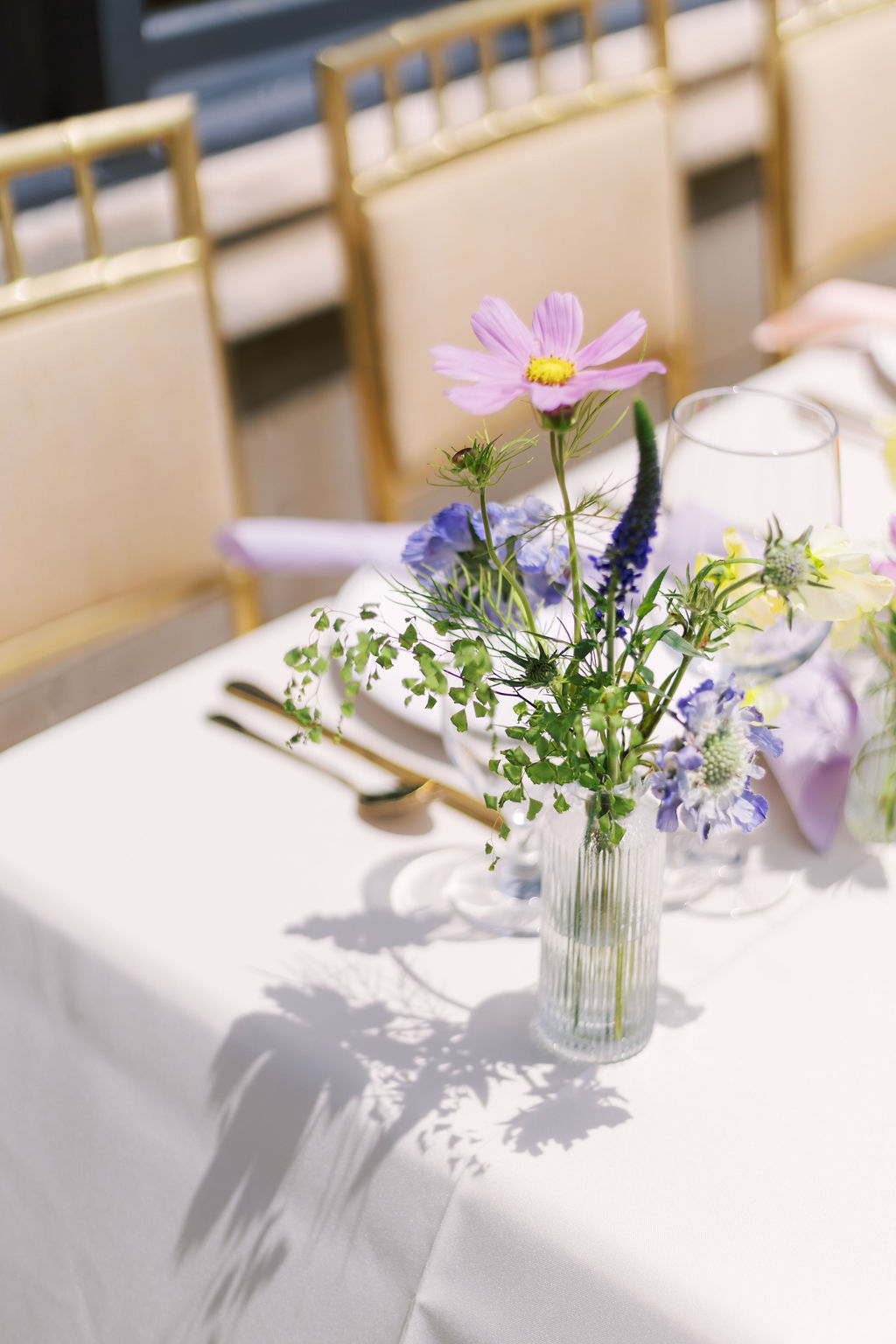 bud vase with flowers on outdoor wedding reception table