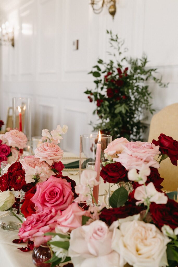 pink and red florals on wedding head table