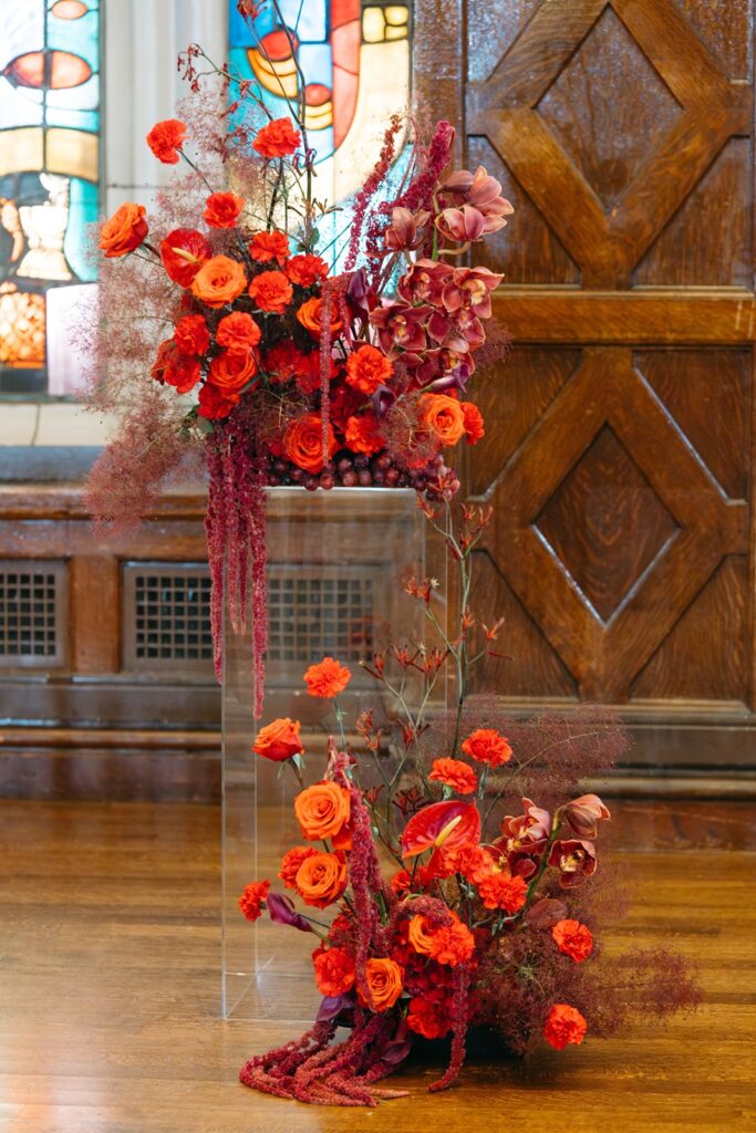 red wedding flowers ceremony pedestals at altar at Hotel Kansas City