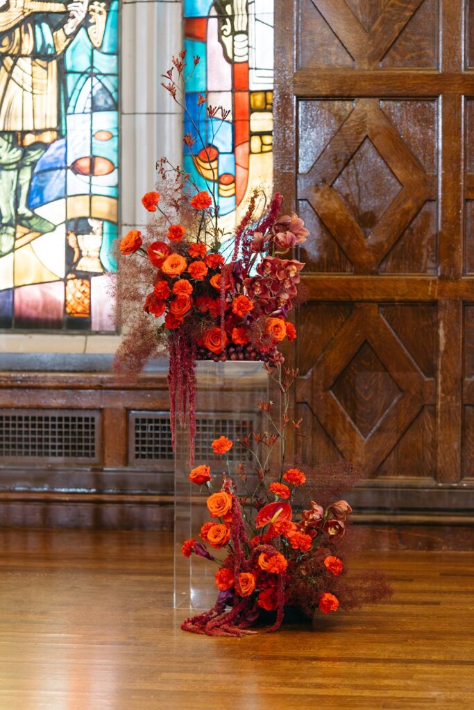 red wedding flowers ceremony pedestals at altar at Hotel Kansas City