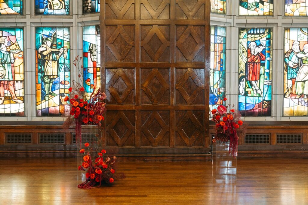 red floral wedding ceremony at Hotel Kansas City's Tudor Ballroom
