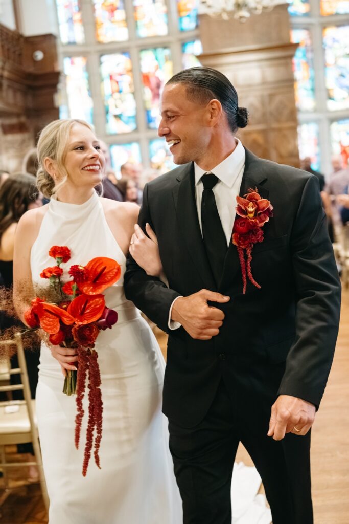bride & groom walk back down the aisle at hotel weddings ceremony in the tudor ballroom