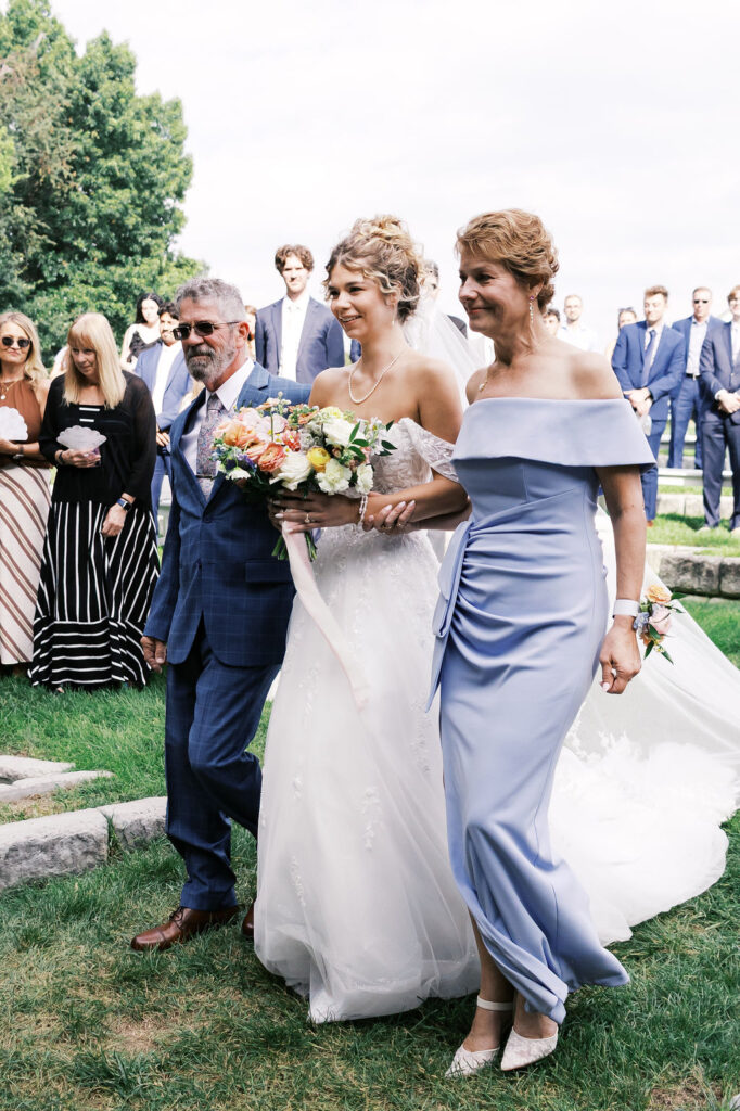 bride walking down the aisle at countryside chalet wedding ceremony