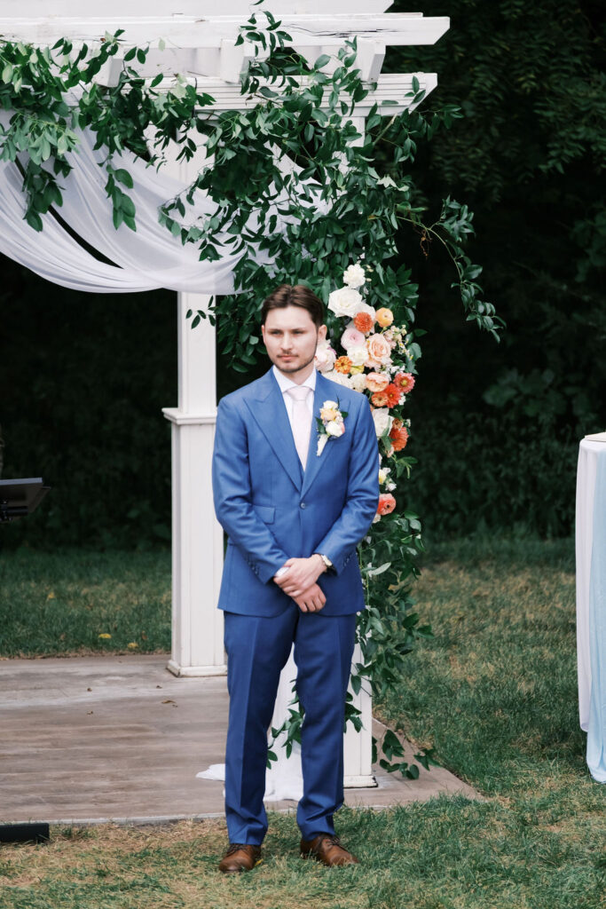 countryside chalet wedding ceremony- groom waiting for bride