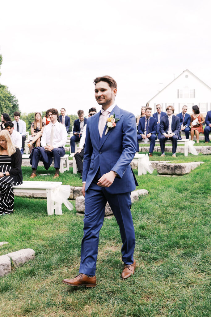 groom walking down the aisle at countryside chalet wedding ceremony