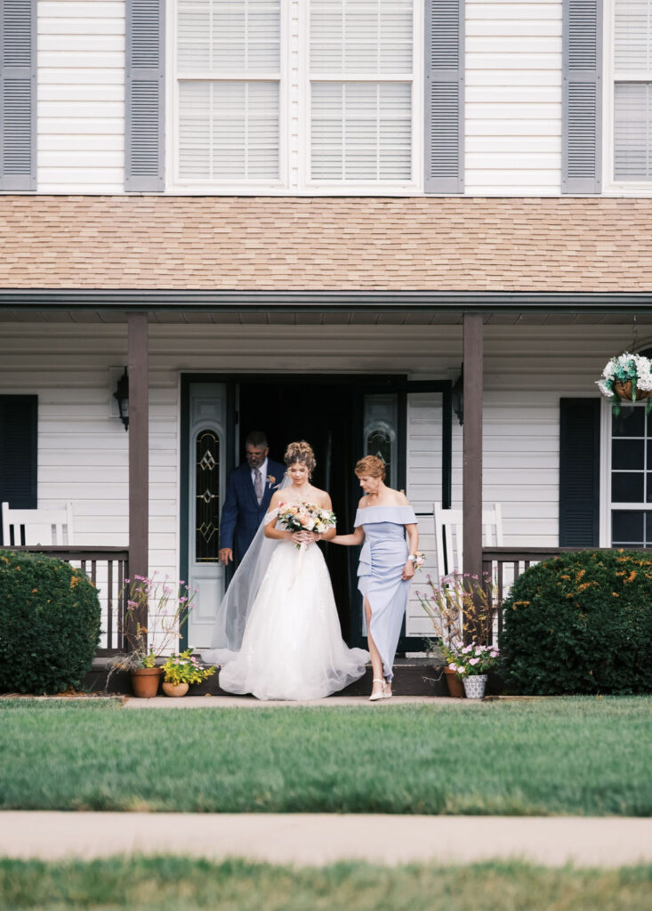 bride walking down the aisle at countryside chalet wedding ceremony