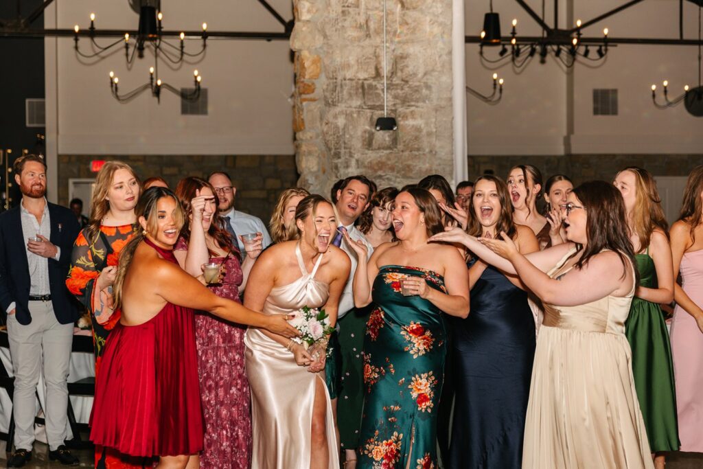 bouquet toss at Stone Manor wedding reception