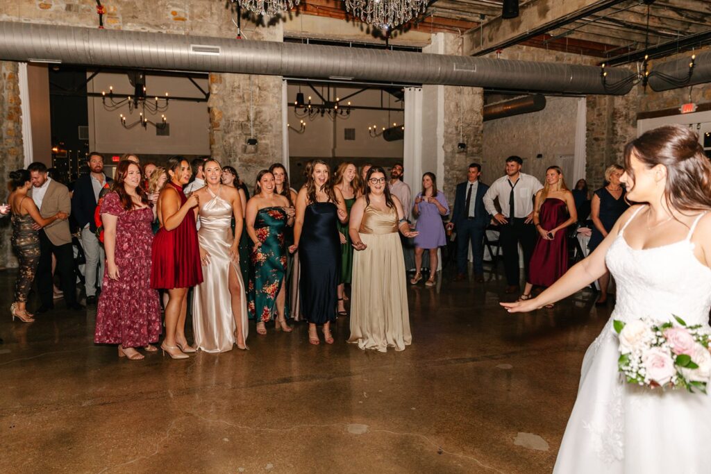 bouquet toss at Stone Manor wedding reception