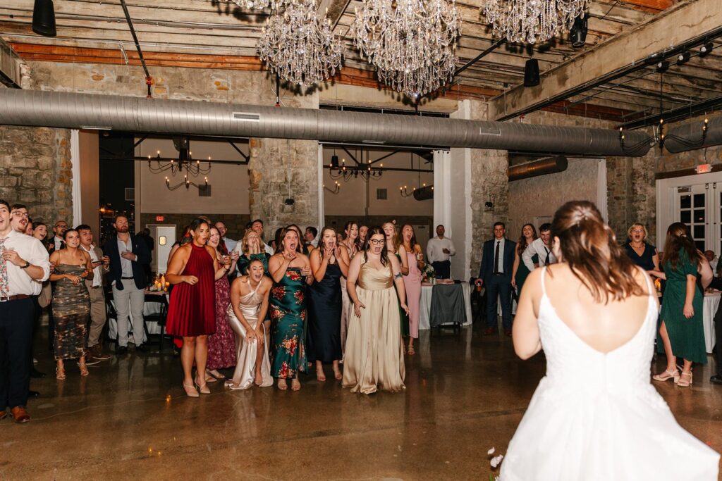 bouquet toss at Stone Manor wedding reception