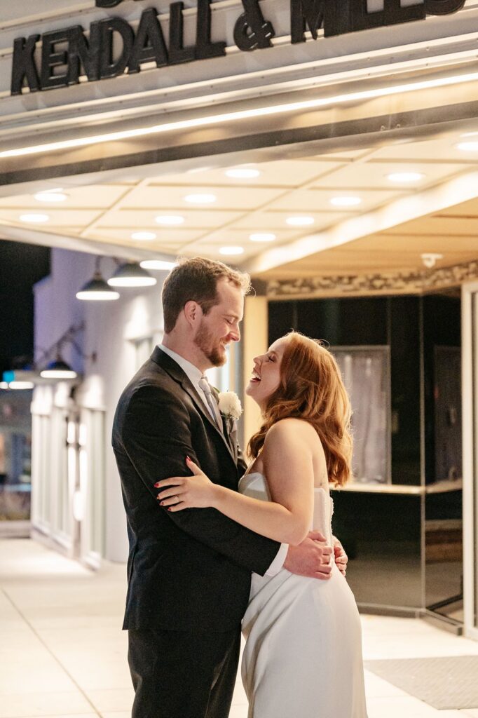 couple outside of Mission Theatre bulletin board