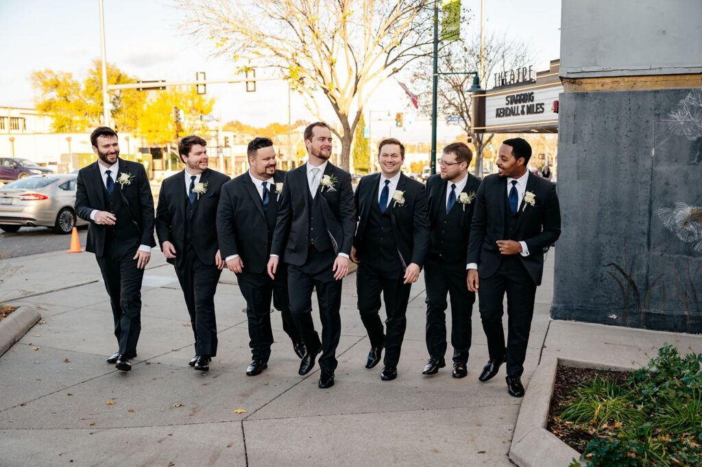 wedding party groomsmen photos outside of Mission Theatre